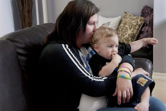   Andrew Vaughan / THE CANADIAN PRESS  Single mom Amy Young cuddles her 15-month-old son Striker in this 2012 Canadian Press file photo.